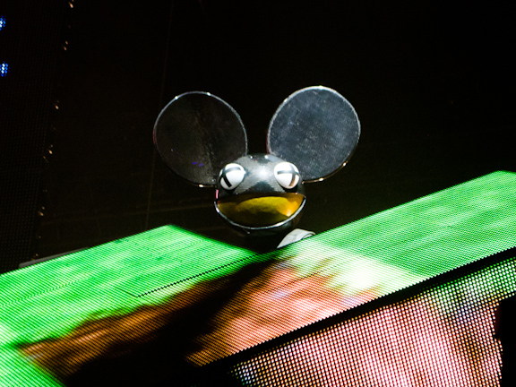 deadmau5 performing on a green-lit VELD Music Festival stage.