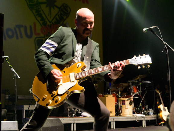 Gogol Bordello guitarist performing during a Toronto concert.